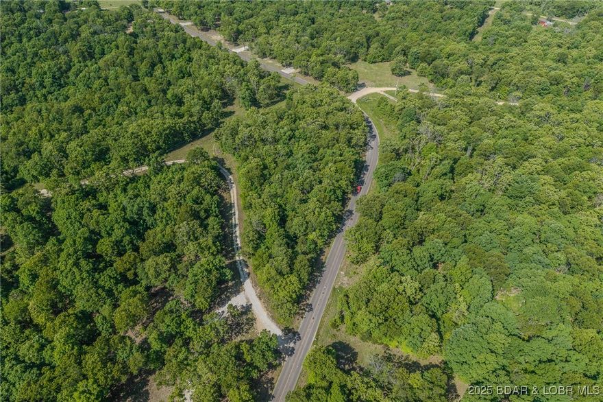 Excellent building lot consisting of 3.01 acres located on Ivy Bend and just off Hwy 135. Seller has just cleared under brush and installed a circle rock driveway. Electric is on property. Lot is ready to be built on and is just 10 minutes from Laurie city limits. Minimal restrictions. Come stake your claim in a 3-acre parcel at the beautiful Lake of the Ozarks.