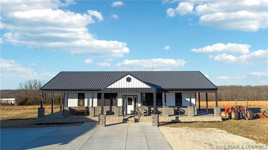 455 Camping Paradise Drive in Roach, MO offers a rare opportunity to own 21.2 acres of usable countryside near Lake of the Ozarks. Built in 2024, this one-level home features 2 bedrooms and 1.5 bathrooms with an open, comfortable layout designed for everyday living. The bright kitchen flows into the living and dining areas, complemented by a durable metal roof and efficient ductless mini-split heating and cooling.

The property is set up for both function and flexibility. A detached 3-car garage/shop includes a roughed-in half bathroom, offering added convenience and future potential. The barn is configured with two separate fenced lots, ideal for animals, equipment, or hobby use. The acreage offers a mix of open and wooded ground with level areas and scenic views—perfect for recreation, privacy, or expansion.

Private well and septic are in place, rentals are allowed, and the location provides easy access to Camdenton, Hwy 54, and all the amenities of Lake of the Ozarks.