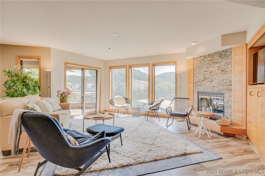 Beautiful, light and bright 2 level condo that feels more like a home than a condo! Featuring 3 bed/3 bath, this spacious unit is conveniently located just one level down from parking for easy access. Enjoy lakeside living with a 12x40 boat slip and 10,000 lb lift right out front of the unit, perfect for worry free boating. The home boasts large balconies with lake views, custom cabinetry and a cozy stone fireplace. Recent updates include a new HVAC in 2024, ensuring comfort and efficiency year-round. Located on the Osage Arm MM#3 prime spot by land and water, close to everything you need while still maintaining a peaceful, private setting.