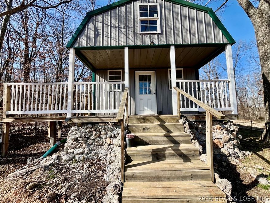 This cozy tiny home offers a simple, low-maintenance lifestyle with just enough space to make it your own and sets on almost 5 acres.  Inside, you’ll find a functional layout with 1 bedroom, a loft, kitchen, living area, and washer/dryer hookups—perfect for full-time living, a weekend escape, or even a rental opportunity. The covered front porch and back deck add extra living space, ideal for relaxing and enjoying the quiet surroundings. With no restrictions, you have the freedom to use the property how it fits your needs—whether that’s a getaway spot, investment property, or a place to simplify and slow down. A few updates like fresh paint and flooring could quickly elevate the space and add value.Located close to a public boat ramp, it’s a great option for anyone who loves easy access to the water without the price tag of lakefront property.