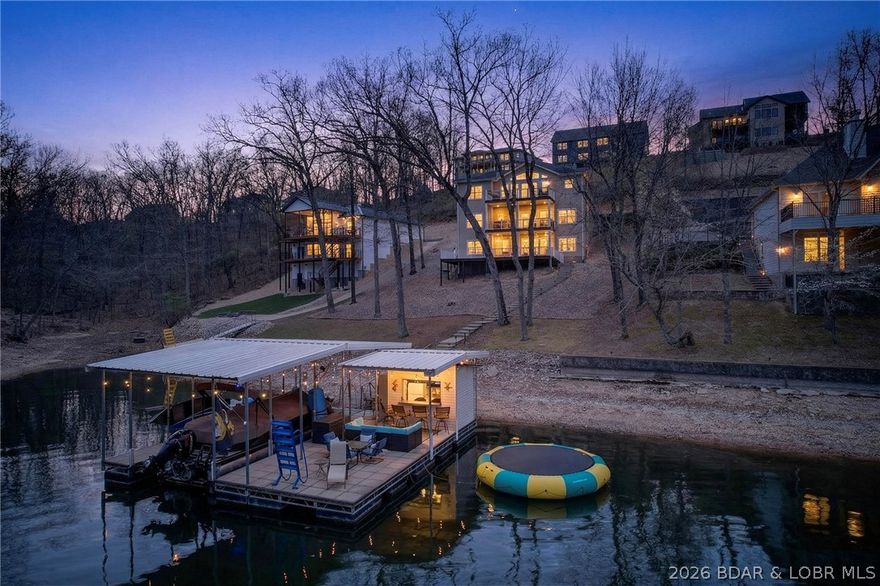 Tucked away in the highly sought-after Beacon Pointe subdivision, this 5-bed, 4.5-bath lake home offers the perfect blend of luxury, comfort, and location—just minutes from Osage Beach & Lake Ozark. This beautifully maintained community features a clubhouse, pool & playground, creating an ideal setting for both relaxation and recreation. If these walls could talk, they’d tell stories of laughter-filled gatherings & unforgettable memories shared with family & friends. This home offers a spacious lakeside primary suite featuring his & hers walk-in closets & oversized custom shower. The mid-level is built for gathering, complete with a welcoming family room, game table area, private ensuite, 2 additional bedrooms, and a full bath, along with access to a screened-in deck for enjoying peaceful lake views. The lower level is all about entertainment—featuring a pool table, dart board, wet bar, an additional bedroom and full bath—making it the ultimate hangout space. Situated in a fabulous cove location, the gentle waters create a calm, safe environment for swimming & relaxing on the dock. The awesome boat dock sets the stage for endless lake days & cherished memories for years to come.