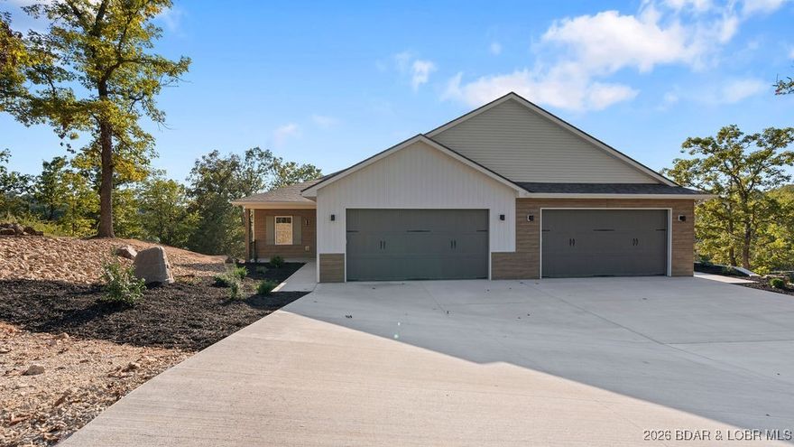 NEW BUILD, LAKE VIEWS, QUALITY CRAFTMANSHIP! Discover space, comfort, and lake convenience in this stunning new build featuring 4 bedrooms, 3.5 bathrooms, and 3,718 sqft across two finished levels. The main level (1,870 sqft) includes a stunning master suite with two walk-in closets, dual vanity, gorgeous walk-in tiled shower, and soaking tub, a living room with a 60 inch electric fireplace, dining room, kitchen, and a half bath, making this easy one-level living. The lower level (1,848 sq ft) offers 3 bedrooms, including one with a private ensuite, a full bath, large family room, game room with wet bar, and a utility room—perfect for entertaining or hosting guests. Finishes include laminate flooring, carpeted bedrooms, and tile flooring for both style and comfort. The large finished two-car garage offers plenty of space for an extra car, a golf cart, or storage. This villa also comes with a 14x46 boat slip, making lake life that much easier. A perfect blend of function, design, and lake living awaits!