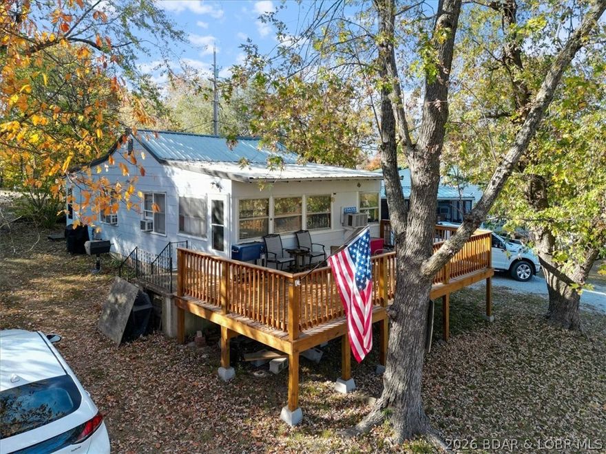 Escape to this 2 bed, 1 bath lakeside retreat located on 3 spacious lots! This charming home boasts a great view of the lake which can easily be enjoyed from the expansive deck, ideal for morning coffee, evening sunsets, or entertaining guests.  The property also features a 24x30 metal building with concrete floor, perfect for additional storage, a workshop, or a hobby space.  A short stroll away, you will find a swim beach for relaxing summer days and a community boat ramp, providing easy access to the lake for boating and water sports.  Conveniently located within walking distance is a popular restaurant and bar, this property allows you to enjoy lakeside living with the added luxury of nearby dining and entertainment.  Whether you are looking for a weekend escape or a peaceful full-time residence, this lakeside gem offers everything you need for a perfect retreat.