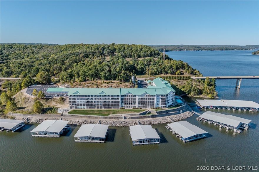 Welcome to your lake front escape at Sunset Palms! Fully gated complex at the 35mm and right off Hwy 5 with easy access into Camdenton or Sunrise Beach for all your shopping and dining needs. This self-managed complex is super well maintained and offers massive views of the main channel. First class amenities such as clubhouse featuring a full kitchen, game room with pool table, lakeside pool and hot tub and two elevators servicing the building. Walk in unit that offers 3 bedrooms, 2 full baths, screened in deck, 2 guest bedrooms on the parking lot side and lake side master suite with attached bath with double vanity sinks and walk in shower. Open kitchen/Living/Dining area with screened in deck. Kitchen has beautiful tile flooring, honey maple cabinets with crown molding and stainless appliances! Also included is a 12x36 slip with a 6,000lb hoist. Unit will come partially furnished. Complex does not allow any short-term rentals! Come experience lake life living at its finest.