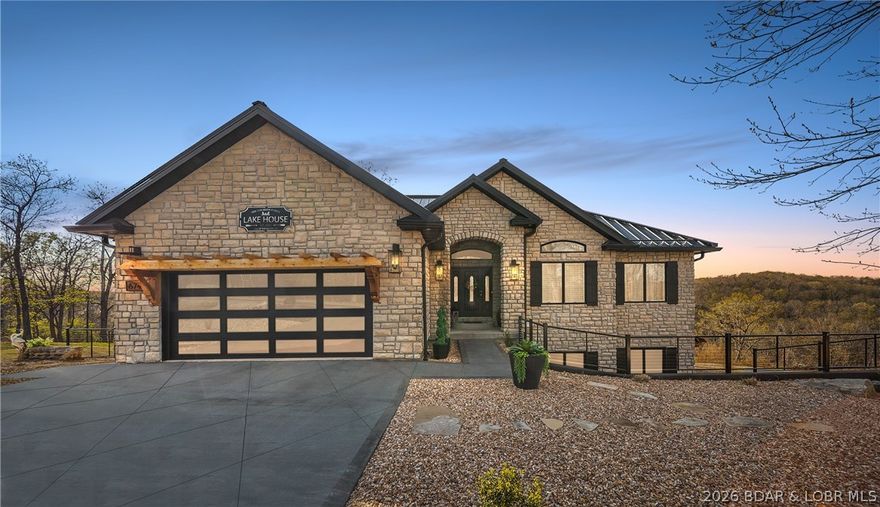 Tucked into a private setting in the heart of town, this stunning home offers year-round lake views and 3 acres with no HOA—perfect for relaxing, entertaining, or expanding. The spacious layout features 6 bedrooms, 4.5 bathrooms, two living areas, a safe room, and two laundry rooms. Enjoy two luxurious primary suites with spa-like baths and high-end showers. A standout feature is the versatile basement en suite, ideal for a guest suite, man cave, workshop, or creative space. Recent upgrades include new garage doors, fencing, ceiling fans, interior lighting, new granite on the kitchen island, a double oven and more. The finished, climate-controlled garage feels like an extension of the home, complete with modern finishes, dark accent walls, rich wood flooring, updated lighting, and built-in shelving—perfect for car enthusiasts or collectors. Level, usable acreage offers endless possibilities to add a pool, shop, or more. Luxury, privacy, and convenience come together in this rare property.