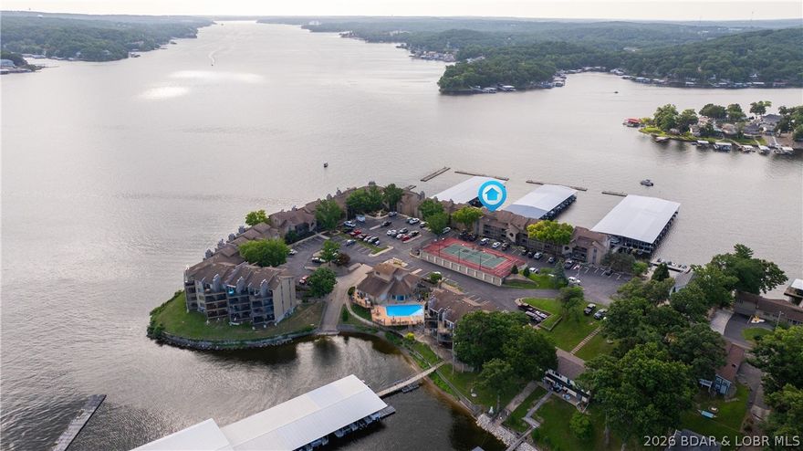 Start your SUMMER RIGHT NOW! If you want to be position 'A' on the lake and need space, this may be it!! Need Boat Slips??--How about a Huge 16x40, a 12x28, and a PWC slip, all with lifts and a Sea-Doo!! High-end finishes with new BEAUTIFUL granite counter tops. Kitchen is set up to impress even the pickiest of chefs. The top floor views of the main channel and the quiet cove go on forever. 2nd floor has an office and recreation room that's a perfect secondary living area. Featuring two primary En Suites (up & down) for privacy, quests, or just getting away from your company that won't want to leave. Beautifully tiled bathrooms, showers and floors. Handcrafted, professional workmanship from floors to ceilings and woodwork to countertops. Sought after Sunrise Ridge Condos feature numerous amenities to keep your group well entertained. Check out the Pool, Sauna, Hot Tub and Tennis/Pickleball Courts and much more, all centered around the Clubhouse! This one's ready for you to RELAX and enjoy the LOTO lake life. All conveniently located at the 10mm. You'll find shopping, grocery, dining and endless entertainment, by land or water. Come take a look! You'll love it!!