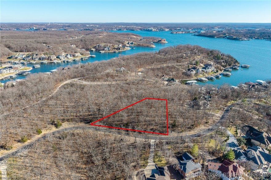 This Lakeview lot at The Villages at Shawnee Bend offers scenic views of the Lake of the Ozarks paired with the amenities of a premier master-planned community. Enter through the striking grand waterfall entrance and experience a neighborhood designed for both relaxation and recreation. Homeowners enjoy a welcoming clubhouse, multiple community pool, championship tennis courts, and pickleball facilities, as well as parks, and playgrounds. With paved roads and underground utilities in place, this lot is ready for a thoughtfully designed home that captures the lake views while embracing a vibrant, resort-style atmosphere.