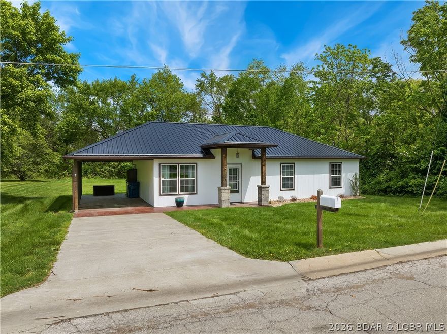 Newer Ranch Home on level lot.  Nice front Yard, Covered Porch and Carport.  There is open Living/Kitchen/Dining rooms with a Vaulted and designed Galvanized Ceiling.  Laminate Flooring throughout and the Living Room has an Electric Fireplace.  The Kitchen has lots of Cabinets, Breakfast Bar, Stainless Steel Appliances and Pantry.  There is also some Wood Designed Walls and Ceilings.  The Master Bedroom features Galvanized Ceilings and Master Bath has a Walk-In Closet and Shower/Tub.  The 2nd Bathroom has a Walk-In Shower.  There is a nice back Yard, smart Siding, Metal Roof, Heat Pump, new Seamless Guttering and on demand Hot water Heater.  Nice location in Town.