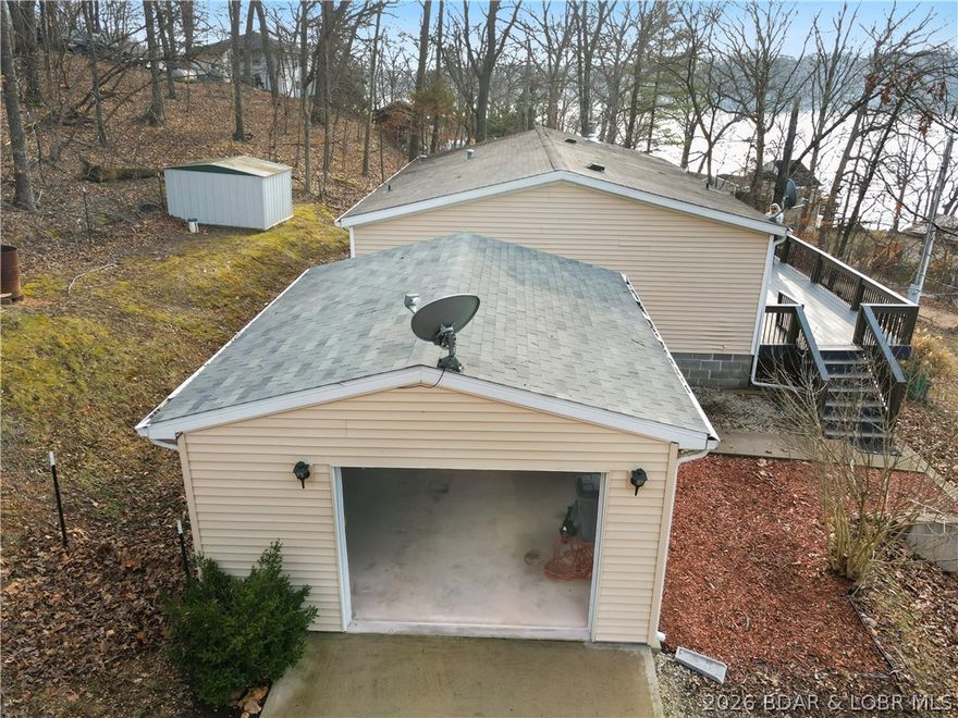 Peaceful Lakeview Retreat Near the Quiet Side of Lake of the Ozarks!  Enjoy relaxing lake life in this charming 3-bedroom, 2-bath lakeview home located in the desirable Gravois Mills area near Big Dick’s on the quiet side of the lake. This manufactured home is permanently affixed to a crawlspace foundation, offering both stability and comfort in a serene, natural setting.  Step inside to find fresh newer carpet and a comfortable floor plan designed for easy living. The home features a bright sunroom perfect for morning coffee or evening sunsets, along with a large composite deck ideal for entertaining, grilling, or simply enjoying peaceful lake views.
You will love the detached garage for extra storage or workshop space, low-maintenance outdoor living areas with huge composite deck, and a tranquil setting that captures the relaxed atmosphere of the lake.  Whether you're looking for a full-time residence, weekend getaway, or investment property, this home offers the perfect blend of comfort, convenience, and the laid-back charm of the quiet side of Lake of the Ozarks.