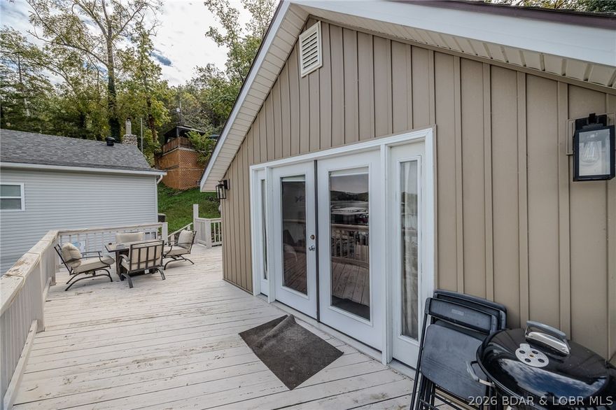 Escape to the quieter side of the Lake in this beautifully updated 2-bed, 1-bath cabin with 980 sq ft of inviting living space and breathtaking panoramic views. Perfect for peaceful getaways or weekend lake living, this property comes fully furnished and move-in ready. Inside, you’ll find a bright, open layout with modern finishes and thoughtful updates on the exterior completed in 2025 — including new wrap siding and trim, staircase, banisters, railings, paint, windows, and a brand-new boat lift. Step outside to the expansive deck overlooking the water — perfect for morning coffee, evening grilling, or simply soaking in the lake breeze. A gentle walk leads you to the private dock featuring two boat slips, great water depth, and a calm cove ideal for swimming or paddle boarding. Nestled in a peaceful cove off the Big Niangua, you’ll enjoy the best of both worlds — tranquility and quick access to popular lakefront restaurants and attractions. Whether you’re looking for a personal retreat, vacation rental, or low-maintenance second home, this lake cabin checks every box.