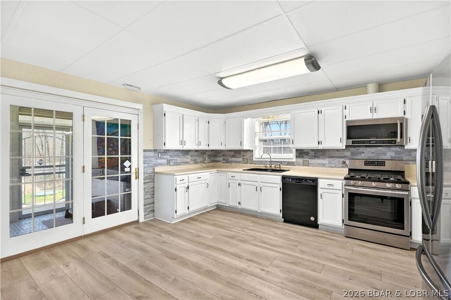 Welcome to this charming 3-bedroom, 1-bath home nestled in the heart of Gravois Mills! This energy-efficient property offers the perfect blend of comfort and value, with thoughtful updates throughout, including a new septic tank for added peace of mind. Enjoy beautiful lake views right from your own home, and unwind year-round in the sunroom—complete with a hot tub that makes every season feel like a retreat. The fenced-in yard provides a great space for pets, play, or relaxing outdoors. Whether you're looking for a full-time residence or a weekend getaway, this cute and cozy home is ready to welcome you!