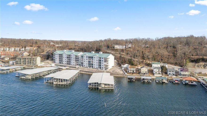 Experience lakefront luxury in this fully furnished 4 bed, 4 bath condo in the heart of Lake of the Ozarks. With stunning panoramic water views  and spacious open-concept living, this two level unit is perfect for full-time living or weekend escapes at Lake of the Ozarks! Two bedrooms are en-suites, offering comfort and privacy for family and guests. Step onto the private balcony to take in breathtaking sunsets over the lake—your front-row seat to serenity. The bright living and dining areas flow effortlessly, ideal for relaxing or entertaining. This unit includes a 14x36 slip, and 2  exterior PWC spaces! Located minutes from top dining, shopping, and entertainment, on the Bagnell Dam Strip - you'll have the best of lake lifestyle at your fingertips. Whether you’re boating all day or unwinding at sunset, this condo offers the ultimate blend of adventure and tranquility. Don’t miss your chance to own this rare gem—schedule your private showing today! An additional 32 x 12 slip is for sale for $15,000