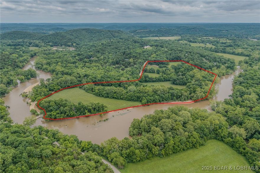 Wake up to wide-open space, flowing water, and true freedom.
Set on 35 acres of peaceful countryside just 10 minutes from Camdenton, this rare riverfront property offers over 2,000 feet of pristine, swimmable, fishable, kayak-ready river frontage—your own private outdoor playground.

The solid 3-bedroom, 2-bath home is thoughtfully positioned to take in the land, complemented by a detached 2-car garage and a 912 sq ft guest suite above—perfect for extended family, guests, or flexible use. A 30x50 insulated shop with concrete floors and a car lift provides the ideal setup for projects, equipment, or serious hobbies.

Winding trails lead you through open meadows, productive hay pasture, and down to the river, while a spring-fed, stocked pond adds even more recreational opportunity. Wildlife, water views, and wide-open skies create a setting that feels worlds away—yet remains conveniently accessible on a county-maintained road.

Whether you’re an outdoor enthusiast, hobby farmer, rancher, or seeking an off-grid lifestyle with room to breathe, this property delivers space, privacy, and a way of life that’s increasingly hard to find.
