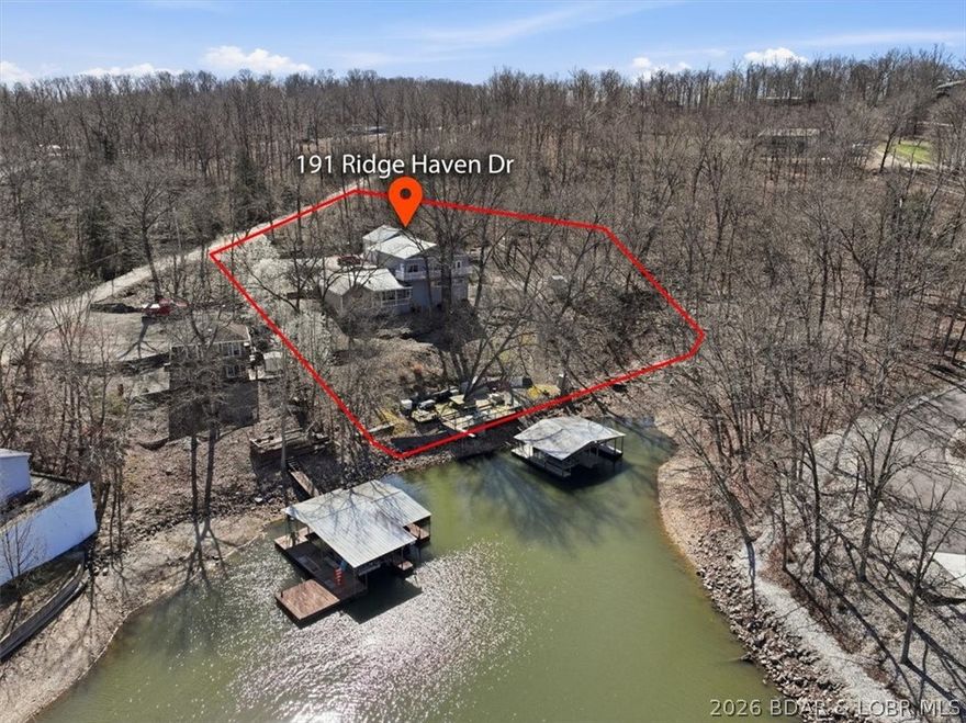 Brand new 1500 gallon septic installed and certified.... Welcome to an entertainer's dream with an unbeatable location by both road and water! Nestled on the 34MM, directly across the channel from the iconic Captain Ron's, this lakefront retreat offers over 150 feet of shoreline and a 2-well dock with deep water, perfect for enjoying Lake of the Ozarks to the fullest. With 5 spacious bedrooms, 5 bathrooms, and a tall 2-car attached garage, there's plenty of room for family and friends. A private bar with a band stage - ideal for hosting unforgettable lake parties after a day on the water. Hit the lake, then bring the fun home. This is lake life at its best! Don't miss your chance to own this one-of-a-kind lakefront getaway- schedule your private showing today and start living the Lake of the Ozarks lifestyle!