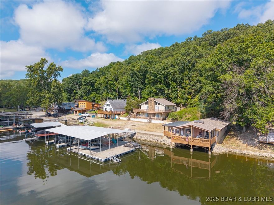 Incredible views with two beautiful homes that come furnished, set the stage for this one-of-a-kind property. This property is turnkey in both houses with 140 Feet of lakefront, 68'X40' Concrete Dock, 3 slips, large swim platform and swim ladder, 2 Boatlifts, dual PWC lift, as well as 2 more separate PWC lifts,It is like having your own resort. New windows and tile floors have just been installed and the wonderful covered deck that sits out over the water is absolutely beautiful. Potentially, both houses can be used as vacation rentals providing an excellent income. The large private cove is wonderful for swimming, with all the Lake activities. All the popular places to go on the lake are close by water as well as by road. Great shopping near by and all the nightlife and wonderful events the Lake has to offer. Again this is a one-of-a-kind property that has so much to offer with so much potential, can be used for private family homes or rental income. This is a must see!!!