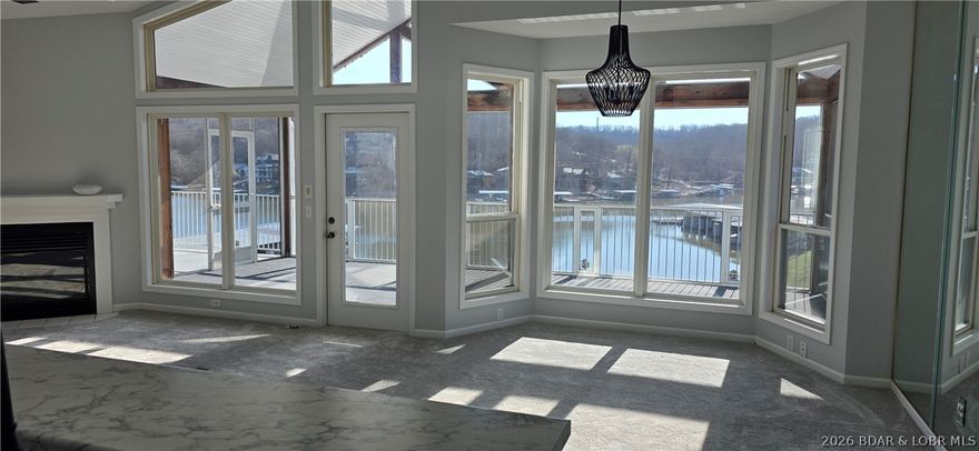 If You are looking for a move in READY unit, then this one is for you.  Complete update in 2026 from all new paint, new flooring, new appliances, new HVAC 2025.  3 master bedrooms, open concept living room, dining, kitchen area.  Large windows that bring in natural sunlight and great view.  Awesome screen porch for entertaining and enjoy the summer weather.  Included is a boat slip, boat hoist and a one car garage.  Located at the 1 Mile Marker of the Big Niangua that is close to places like Fish and Company, Larry's on the Water and the Cave.  There are lots of amenities with the Shores of Camelot for your enjoyment.  Located on the top floor and end unit.