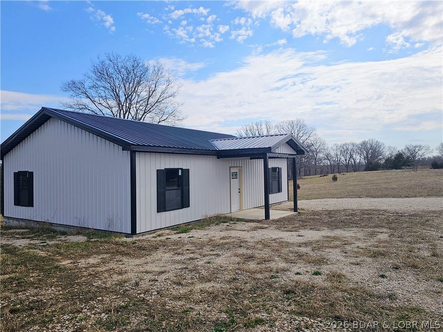 Private country setting with endless potential! This 30x40 new construction home is dried-in and ready for your personal finishing touches. The home features a 3 bedroom, 2 bath layout with 9-foot interior walls framed with 2x4 studs, a spacious feel and solid structure to complete as you choose.Situated on  6.5 acres, the property includes a drilled well, and the home is already plumbed and stubbed for a septic system, making the finishing process much easier. Electric is available at the road.Outdoor enthusiasts will appreciate the excellent deer and turkey hunting right on the property, or simply enjoy watching wildlife from your future porch.Conveniently located just minutes from the North Shore of Lake of the Ozarks and approximately 10 minutes from Coffman Beach Conservation Boat Ramp, offering quick access to great fishing and boating.Centrally located between Versailles, Barnett, and Eldon, and only 20 minutes to Osage Beach for shopping, dining, and lake activities. Several restaurants and convenience stores are also just minutes away.A great opportunity to finish a home exactly the way you want it while enjoying privacy, acreage, and easy access to Lake of the Ozarks.