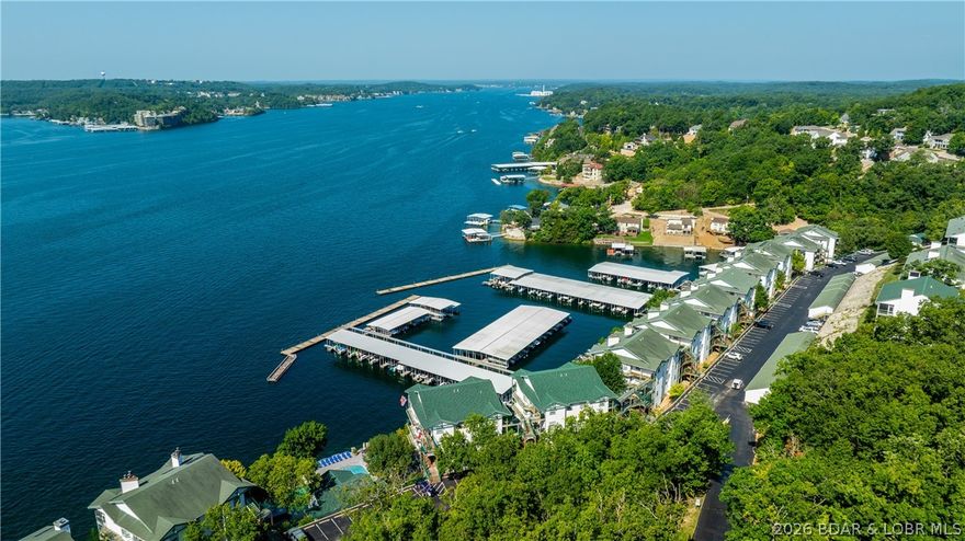 Fall head-over-boat-shoes for this charming 2-bedroom, 2-bath walk-in unit at Harbour Towne, perfectly perched with a sweeping main-channel view of Lake of the Ozarks! With 1,070 sq. ft. of breezy, comfortable, lake-lovin’ living space, this condo packs the perfect mix of relaxation and fun.
Inside, you’ll find tile flooring, newer carpet, and an electric fireplace in the primary suite that sets the mood for cozy evenings after long lake days. The screened-in porch, complete with tile floors and sun shades, is the ideal chill zone for sunrise coffee, sunset cocktails, and everything in between—trust us, this porch knows how to deliver the vibes.
Positioned just steps from the community pool, you get convenience without the noise—close enough to cannonball, far enough to unwind. The unit comes fully equipped with all appliances, plus a 12x32 boat slip in Dock G-4, so your lake adventures are always ready to launch.
This Harbour Towne gem is the total package: walk-in access, killer views, perfect amenities, and that unmistakable Lake of the Ozarks magic. It’s more than a condo—it’s a lifestyle you’ll fall for instantly.