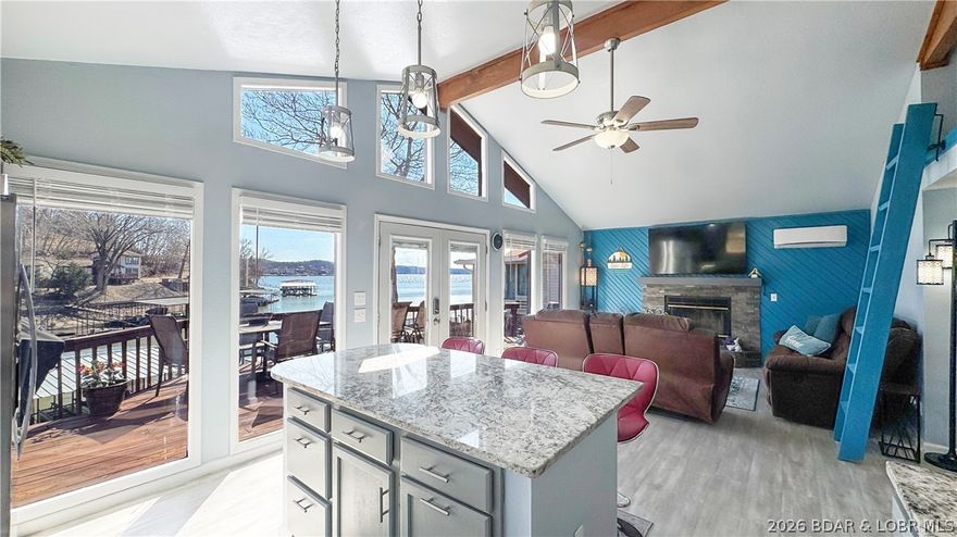 Set at the 46MM with 68’ of shoreline, this lakefront property offers a comfortable setup with easy access to the water and a clean, updated interior. The private dock features two 10x28 slips with hoists and a swim platform, making it ready for full lake use from day one. Inside, this 2 bedroom, 2 bathroom home offers approximately 1,080 sq ft with a fully renovated kitchen and main living space. Vaulted ceilings and large windows bring in natural light, while the open layout connects the kitchen, dining, and living areas and leads directly to the lakeside deck. A loft area adds additional flexibility and is currently used for extra sleeping space, but could also serve as storage or a bonus area. Just off the home, a finished she-shed provides even more usable space for guests, hobbies, or a private retreat. The roof was replaced in 2021, and all matching appliances have been updated since 2022. With open parking and a low-maintenance exterior, this property is well-suited for a straightforward lake getaway with updated interiors and functional outdoor space.