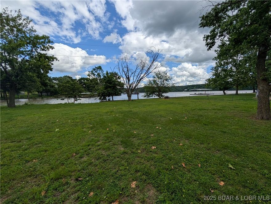 This acreage has a beautiful view of Lake of the Ozarks, MO, located on 9.5 acres at the top of the hill. The vantage point of the buildable property creates the possibility of a huge lakeview, which also includes a lakefront dockable lot below. Cut down or thin out some trees, and you will have a magnificent lakeview. Also included, and only a minute down the hill, is a very flat 80 ft lakefront lot located at the bottom of Fifties Rd. The lakefront lot is dockable per Ameren, but not buildable, which is why the land at the top makes so much sense. Make your dreams come true with your own property at the lake, and it is enough to stretch out, build a home on the acreage, and put in a dock down below on the lakefront. There is a community well that, for a fee, it is permissible to tap into - just put in your own septic and bring your house plans...Come take a peek- electric is already at the property. All that is needed is your dream and vision to make this happen here at the Lake. The land has no restrictions on what can be built - put in a Shouse or a Tiny home and a shop or a nice conventional home - maybe a rental - make some money when you aren't using it...investors...