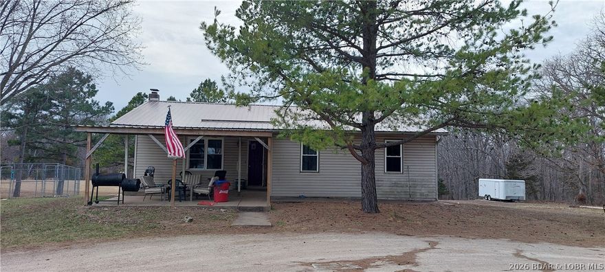Take a look at this raised ranch home situated on 3.3 +/- acres that are level and decorated with a few beautiful pine trees! The home is 3 bedrooms and 1 full bathroom, making it a nice starter home or investment opportunity. The unfinished walkout basement provides ample room for storage or constructing more living space, a man cave, media room or exercise area!  Relax and enjoy watching the wildlife frequenting the property for either the front or the back covered decks! It has a private well and has NO restrictions, NO zoning, NO HOA and NO building codes to hassle you! Secluded from the paved secondary highway by the pine trees, this property has easy, level access directly off the highway. Plenty of open, grassy field for animals, playground or games!  High speed fiber optic internet provides opportunities for a home based business or just for gaming or streaming fun! Although the home needs some finishing touches and some repairs, this could be just what you are looking for! Check it out before it's gone!