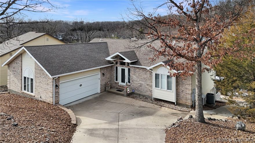 This 5-bedroom, 3.5-bath lakefront home in Four Seasons is well-maintained and offers a practical layout for either full-time living or a lake getaway. The interior provides plenty of room for family and guests, while the outdoor space includes a low-maintenance composite deck that is partially screened-in for added comfort.
A concrete path leads from the house directly to the water, providing a convenient, stepless option to walk down to the private dock. The dock itself is already set up with a boat lift and PWC lifts, making it ready for the water immediately. Since the home is being sold fully furnished, it is a turnkey opportunity that allows you to move in and start enjoying the Lake of the Ozarks and the Four Seasons community amenities with very little setup required.