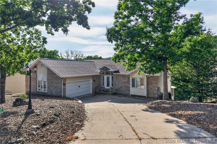 This 5-bedroom, 3.5-bath lakefront home in Four Seasons is well-maintained and offers a practical layout for either full-time living or a lake getaway. The interior provides plenty of room for family and guests, while the outdoor space includes a low-maintenance composite deck that is partially screened-in for added comfort.
A concrete path leads from the house directly to the water, providing a convenient, stepless option to walk down to the private dock. The dock itself is already set up with a boat lift and PWC lifts, making it ready for the water immediately. Since the home is being sold fully furnished, it is a turnkey opportunity that allows you to move in and start enjoying the Lake of the Ozarks and the Four Seasons community amenities with very little setup required.