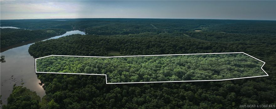 Introducing 25.5 +/- wooded acres with valuable lake frontage on Lake of the Ozarks, offering a rare combination of privacy, recreation, and build potential. Mature hardwood timber stretches across rolling terrain, creating multiple secluded homesite options with scenic views tucked beneath the canopy.

Enjoy fishing, kayaking, and quiet shoreline access right from your own property. Natural draws, thickets, and edge cover support strong deer and turkey movement, making this acreage an excellent choice for hunters and wildlife enthusiasts. Trails could easily be added for improved access, ATV/UTV riding, or hiking.

Whether you’re planning a private retreat, weekend cabin, or future investment, this tract checks the boxes for lake proximity, natural beauty, and year-round recreation. Convenient to boat ramps, marinas, waterfront dining, and local amenities—yet peaceful enough to feel truly removed.

Acreage with lake frontage at Lake of the Ozarks continues to grow in demand and become harder to find. Build, relax, or simply hold as a long-term asset—you won’t want to miss this opportunity. Owner is a licensed agent.