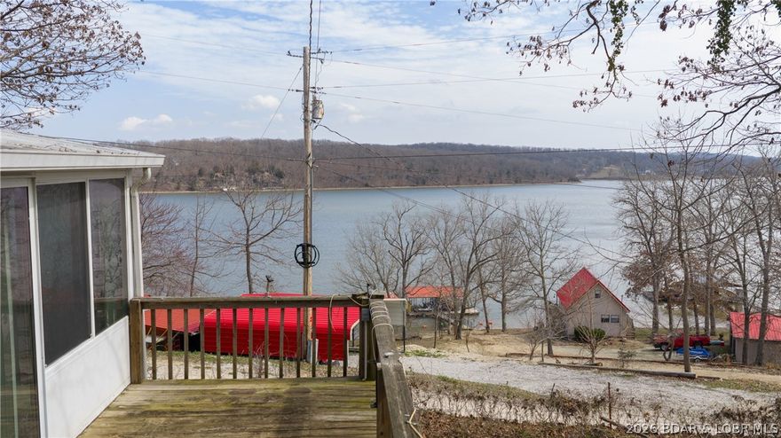 Tucked away in a quiet neighborhood at the 76 mile marker, this fisherman’s dream offers incredible potential and unbeatable lake living. This 3-bedroom, 1-bath home features a huge lake view and convenient lake access, with a boat launch right in front of the home—making it easy to get out on the water anytime the fish are biting. The property includes multiple outbuildings and a large garage/shop, providing plenty of space for boats, gear, tools, or hobbies. Inside, you’ll find a beautiful four-seasons room where you can relax and enjoy the scenic lake views year-round. With tons of potential, this home is a great opportunity to create your own custom lake retreat. With great fishing nearby and a bait shop just a couple doors down, everything you need for the perfect day on the water is close at hand. The neighborhood also provides a lakefront community pavilion for you to use/reserve for your next get together.  So whether you're looking for a weekend escape or a full time lake view home, this property could be your dream retreat at the lake at a budget that won't break the bank.
