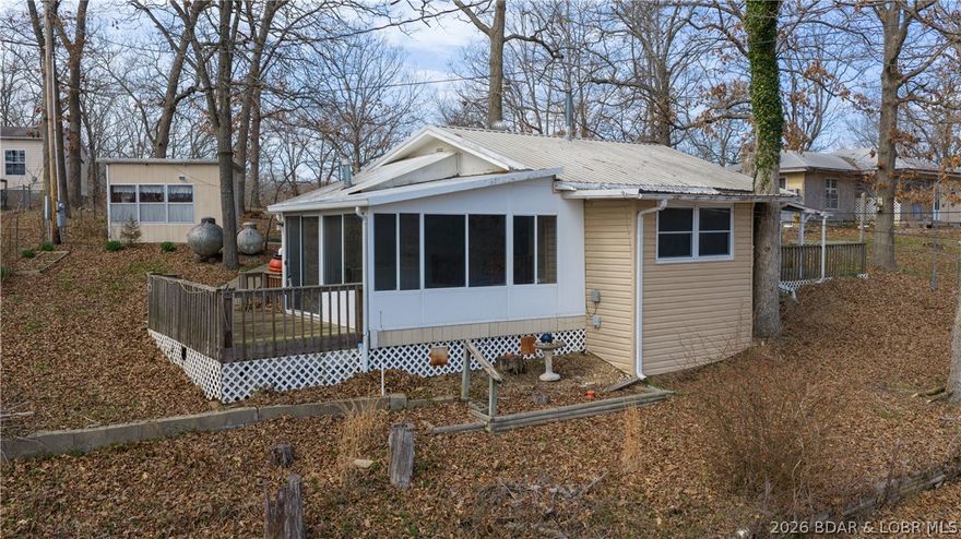 Tucked away in a quiet neighborhood at the 76 mile marker, this fisherman’s dream offers incredible potential and unbeatable lake living. This 3-bedroom, 1-bath home features a huge lake view and convenient lake access, with a boat launch right in front of the home—making it easy to get out on the water anytime the fish are biting. The property includes multiple outbuildings and a large garage/shop, providing plenty of space for boats, gear, tools, or hobbies. Inside, you’ll find a beautiful four-seasons room where you can relax and enjoy the scenic lake views year-round. With tons of potential, this home is a great opportunity to create your own custom lake retreat. With great fishing nearby and a bait shop just a couple doors down, everything you need for the perfect day on the water is close at hand. The neighborhood also provides a lakefront community pavilion for you to use/reserve for your next get together.  So whether you're looking for a weekend escape or a full time lake view home, this property could be your dream retreat at the lake at a budget that won't break the bank.