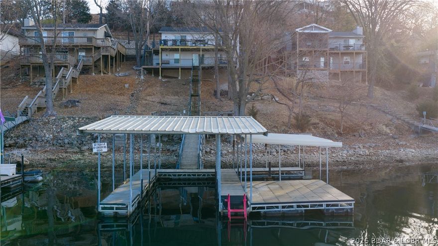 Beautifully updated 3 bed, 2 bath lakefront home at the 3MM in a fantastic deep-water cove! This property offers an expansive dock envelope and a concrete dock with a 12x32 slip plus two PWC slips—perfect for maximizing your lake time. The walk-in level features two bedrooms, a full bath, kitchen, dining area, and comfortable living room. The kitchen shines with stainless steel appliances, granite countertops, and LVP flooring. Downstairs you’ll find a second living area with lake views (easily converted to a 4th bedroom), a dry bar with fridge, an additional bedroom and bath, laundry, and storage. Outdoor living is a dream with a spacious two-tier deck AND a new upper deck, offering plenty of room to entertain and relax on summer nights. Updated in 2020 and selling fully furnished, this home is truly turnkey. Nightly Rentals are allowed so if you are searching for a great investment this is it! Schedule your showing today and start enjoying lake life right away!