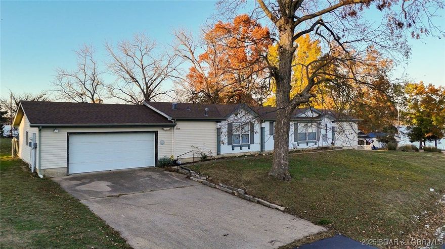 Have you been looking for a FLAT lot, beautiful lake views, great lake access, that won’t break the bank? Then stop what you’re doing now and come see this home! Featuring 270-degree views, single level ranch floorplan, gated entrance to the subdivision, and city utilities, this home is as low maintenance as they come!! With a new roof, this home is ready for you to put your finishing touches on it! Located at the mouth of the Gravois arm, this home is close to EVERYTHING!! From the home, you are minutes away from Tap and Grill, Millstone RV Park & Marina, and just a short boat ride from Jolly Rogers, Alhonna, Camden on the Lake, and Coconuts. Enjoy your days watching the boats go by or throw the boat in the water and enjoy the fun! With ease of living at the forefront of the experience with this property, it is not one you are going to want to miss! Jump on it before it’s gone! Under contract w/ a 48 hr kick-out.
