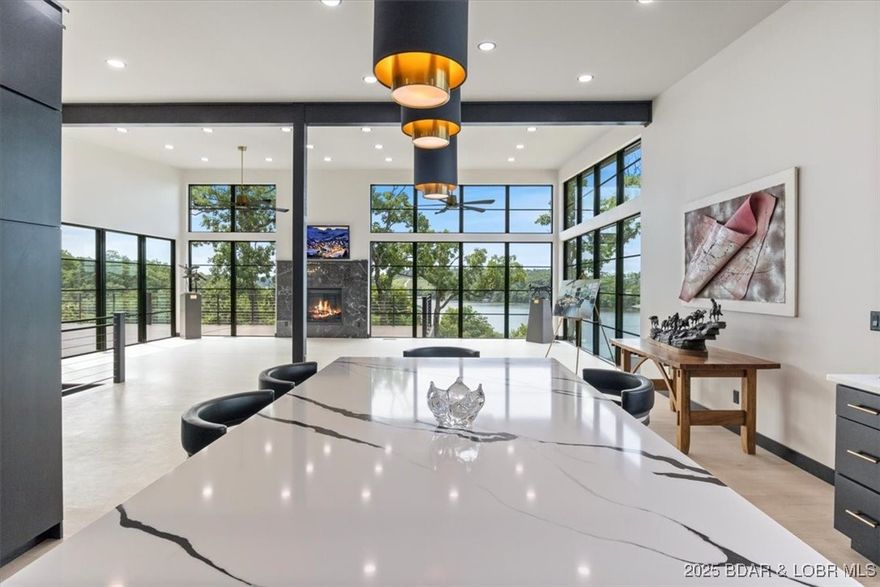 Stunning new modern home with breathtaking views located in Linn Creek Cove! With 3 beds, 3.5 baths, & 2.5 car garage. This 3,636 sf home features exquisite maple hardwood flooring, gas fireplace, designer kitchen with premium cabinetry & gas cooktop, metal roof, and Quaker aluminum windows maximizing the panoramic lake view which faces south. Each bedroom boasts a walk-in closet, custom tile onyx bathrooms and sleek quartz countertops. Enjoy the expansive composite hardwood decking on both levels, complemented by a custom cable deck railing, and the durability of prefinished metal roofing and energy-efficient Diamond Coat Siding. Each level has their own laundry room as well. Additional room on the lower level could be a nice wine cellar. Large safe room/storage. So many great features! Assessments are paid every 6 months.