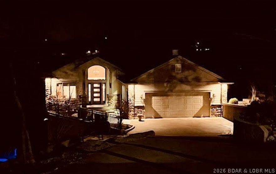 Lakefront Living at Its Best.
Experience lakefront living in this beautifully updated 3 bed, 2.5 bath home with sweeping water views and thoughtful upgrades throughout. Natural light fills the home through large windows that perfectly frame the lake. The open-concept living, dining, and kitchen areas create an inviting space for entertaining or relaxing.

The kitchen offers abundant cabinetry, generous prep space, and seamless flow to the main living area—all positioned to capture the view. The private primary suite provides a peaceful retreat with spacious walk-in closets.

Step outside to multiple levels of decking that extend the living space outdoors, perfect for gatherings or quiet mornings overlooking the water. At the shoreline, enjoy a private two-well dock complete with boat hoist, PWC hoist, and swim deck with slide.

Additional features include an energy-efficient geothermal system, oversized garage with workshop space, extra parking, a roof approximately 2 years old, and numerous updates throughout. Move-in ready and designed for comfort, this property offers privacy, efficiency, and exceptional lakefront living.