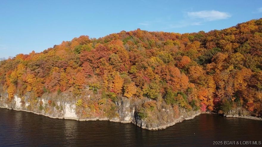 610 Ft. of SHORELINE for $659K! That's only $1,080 a LAKEFRONT FOOT! Breathtaking views of the main channel! Perfect property for a private estate, an investor, villas, homes or condos. This would be a stunning site for a private home with an abundance of nature and seclusion.  Includes 9 plus acres with 610 feet of lakefront.  Build your dream home or homes with a wall of windows to capture this view! SUNSET ESTATES...even the name has a beautiful image.  In summary, this property offers a rare combination of significant lake frontage, acreage, stunning views, and flexible development potential in a prime Lake of the Ozarks location. It's marketed as an ideal spot for luxury living or a lucrative investment.  Nice peaceful location yet close to local amenities.  Don't wait, check it out today and start building your dream property!