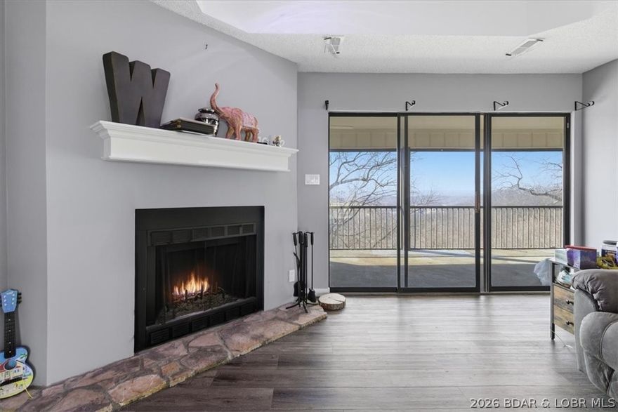 Top-floor living in this well-maintained 3-bedroom, 2-bath condo at Osage Vistas offers a desirable split-bedroom floor plan, providing both privacy and functionality. The spacious living room features a cozy wood-burning fireplace and opens to a covered, screened deck—perfect for relaxing and taking in the scenery. Enjoy the comfort and durability of carpet and vinyl plank flooring throughout. Recent updates include a new HVAC system and hot water heater (2024), giving peace of mind for years to come. The pet-friendly HOA offers an incredible lineup of amenities, including six in-ground pools, BBQ areas, gathering spaces, and scenic walking paths, along with access to Four Seasons amenities. Whether you're looking for a full-time residence, weekend retreat, or investment opportunity, this condo delivers the perfect blend of comfort, convenience, and lake lifestyle! Schedule your tour today!