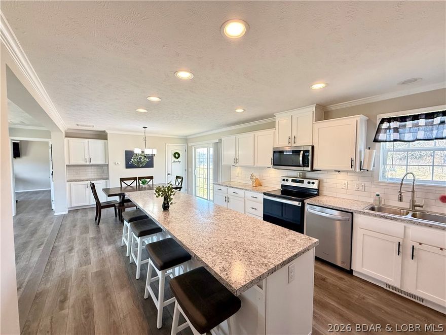 Family homestead, hunting property, and peaceful country retreat all in one. Built in 2023, this 4-bedroom, 3-bath home offers the benefit of newer construction with newer appliances, HVAC, and roof, plus a spacious one-level layout designed for everyday living. Inside, you’ll find an open concept floor plan filled with natural light, a large kitchen with dining bar, coffee bar, adjoining dining room, and two separate living spaces to give everyone room to spread out. The primary suite features a large walk-in shower and double sinks, while the Jack-and-Jill bath between the spare bedrooms is ideal for family convenience. Step outside to 60 acres of privacy with trails, pasture, partly wooded ground, cross fencing, and abundant deer and turkey for outstanding hunting potential. The land was thoughtfully logged with a forester to improve wildlife habitat, with mature trees still remaining. A 1,230 sq. ft. shop, chicken coop, and additional animal storage buildings add versatility for livestock, hobbies, storage, or recreation. All of this in a private setting close to the Big Buffalo Conservation and town for shopping and restaurants.