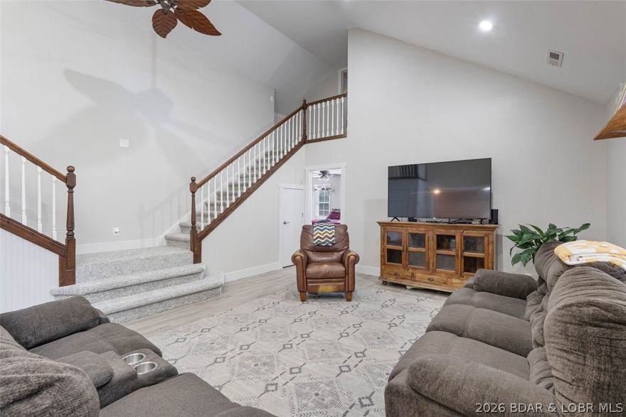 Discover comfort, space and functionality in this beautiful property set on three generous lots on a quiet street with minimal traffic. First impression is the massive wrap-around covered deck that draws you in, perfect for relaxing, entertaining guests or enjoying nature. Inside, the thoughtful design combines open living areas with cozy spaces and main level living. The kitchen is spacious with a generous pantry and dining area. Off the kitchen is a bedroom and full bath. The distinct staircase in the living room leads to the upper level to another bedroom with full bath and a cozy room that can double as a bedroom, play area or study. On the main level, the expansive primary bedroom has a generous walk in closet that flows to the private bath. Adjacent to the primary is a bonus room that could be an office or studio limited only by your imagination. The detached two-car garage provides ample parking and storage, while the impressive 2,500 sq ft metal building offers endless possibilities—ideal for a workshop, hobby space, or business use. This property boasts an expansive yard to enjoy the outdoors along with the added safety of a storm shelter for convenience and peace of mind.