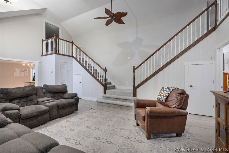 Discover comfort, space and functionality in this beautiful property set on three generous lots on a quiet street with minimal traffic. First impression is the massive wrap-around covered deck that draws you in, perfect for relaxing, entertaining guests or enjoying nature. Inside, the thoughtful design combines open living areas with cozy spaces and main level living. The kitchen is spacious with a generous pantry and dining area. Off the kitchen is a bedroom and full bath. The distinct staircase in the living room leads to the upper level to another bedroom with full bath and a cozy room that can double as a bedroom, play area or study. On the main level, the expansive primary bedroom has a generous walk in closet that flows to the private bath. Adjacent to the primary is a bonus room that could be an office or studio limited only by your imagination. The detached two-car garage provides ample parking and storage, while the impressive 2,500 sq ft metal building offers endless possibilities—ideal for a workshop, hobby space, or business use. This property boasts an expansive yard to enjoy the outdoors along with the added safety of a storm shelter for convenience and peace of mind.