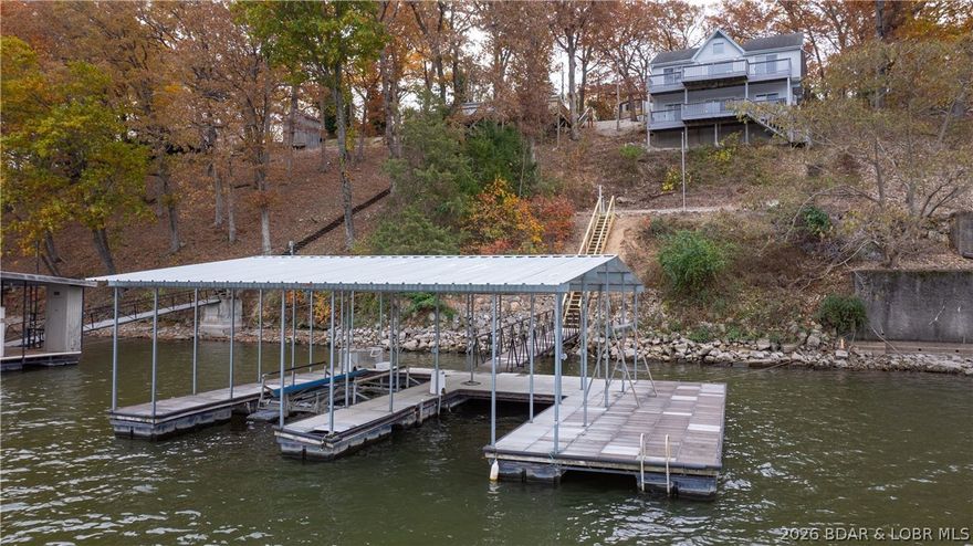 Exceptional lakefront living at this 4 bedroom(2 nonconforming), 3 bathroom home located on the 28 mile marker in Osage Beach. Offering nearly 1,900 square feet, this property features a cove location with approximately 75 feet of lake frontage, and still captures a big lake view. The concrete 2-well dock sits in roughly 40 feet of water, ideal for boating and swimming. Inside, you’ll find two separate living/entertainment areas and an abundance of windows providing excellent natural light throughout. Recent updates include a new septic in 2022, new lift in 2023, some windows replaced, new paint/trim/LVP flooring, wet bar added, and new lower kitchen cabinets. The exterior offers a U-shaped concrete driveway, plus an additional parking pad for extra vehicles or trailers. A flat lakeside entertaining area provides the perfect setting to add a pergola or outdoor fireplace. Conveniently located in Osage Beach, just minutes from shopping and dining along Osage Beach Parkway, is in Miller's Landing cove, a short boat ride to Margaritaville, and within 15 minutes of Camdenton. Nightly rentals are allowed, making this an excellent residence, vacation home, or income-producing property.