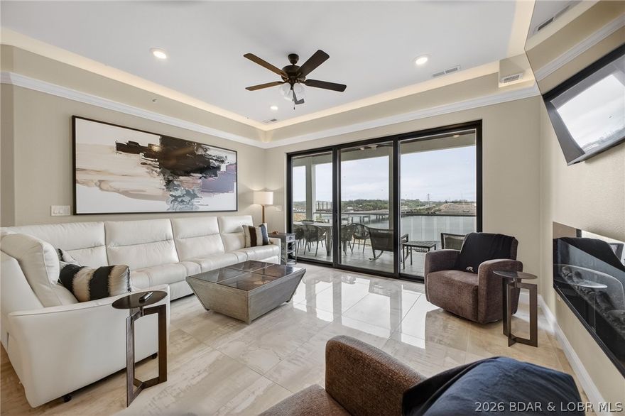 Situated on the top floor as a desirable end unit, this stunning 3-bedroom, 3-bath condo offers the perfect blend of luxury, privacy, and waterfront living! Two of the spacious bedrooms feature private en-suite baths, creating an ideal layout for both owners and guests. Step inside to find exquisite tile flooring imported from Italy, setting the tone for the home’s refined style. The kitchen is a true centerpiece, showcasing beautiful quartz countertops, soft-close cabinetry, and elegant crown molding that continues throughout the living spaces for a polished finish. Enjoy peaceful views and easy access to the water with your included 14x40 deep-water dock slip. The community amenities elevate the lifestyle even further, featuring two large swimming pools, a welcoming clubhouse, a cozy fire pit, and outdoor spaces designed for yard games and gathering with friends and family.  Whether you’re looking for a full-time residence, a weekend getaway, or an income-producing investment, across from the future Oasis Amusement Park,  this top-floor end unit delivers upscale comfort, thoughtful design, and an unbeatable location in the heart of it all.