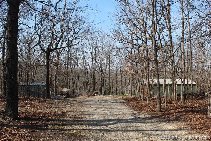 If you’ve been looking for acreage with utilities already in place, this 8.2 acres just off Highway 135 is worth a look. Private well, sewer, and electric are already hooked up — saving you time and money from the start. The property offers a mix of cleared space and woods, plus a usable flat area that works well for building, parking equipment, or even setting up campers.  The unfinished tiny home gives you a head start on a weekend retreat, hunting base, rental idea, or personal project. Three sheds are already on site, including a larger one that would make a great workshop or storage space. With no zoning restrictions, this property offers flexibility — whether you’re an investor, thinking about a small campground setup, or just want room to build and do your own thing.  Conveniently located near several local wineries, the Lake of the Ozarks racetrack, and the Gravois Mills boat ramp, you’ll have easy access to some of the area’s best recreation and entertainment while still enjoying the privacy of acreage living.
