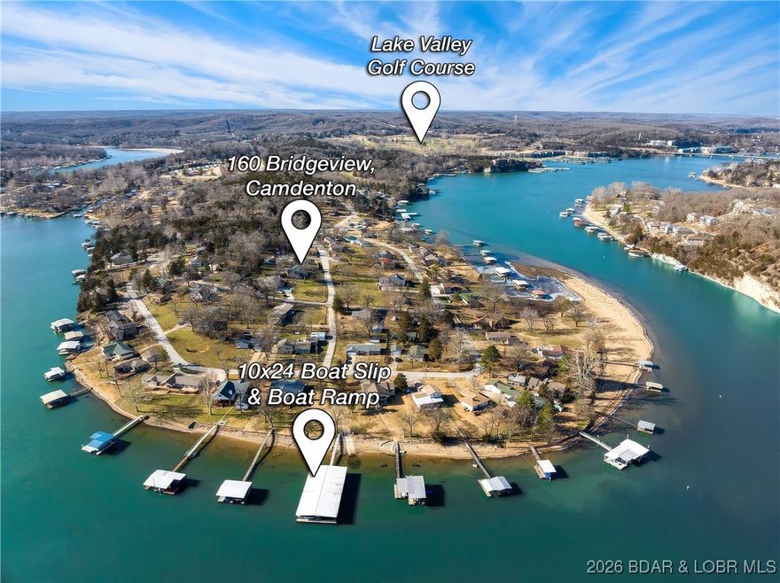 Incredible opportunity for comfortable lake living; and the sellers have invested where it counts. Over the past two years, the home received new subflooring and vinyl plank flooring, a new well pump, and a professionally installed HeliTech system that includes a vapor barrier, French drains, and sump pump. New front and back decks expand usable outdoor space, and a brand-new roof installed in Fall 2025 removes one of the biggest future expenses from the equation. The layout includes a functional kitchen with space to add an island, a huge main living room with an additional flexible room that could be a formal dining room, extra family room, or game room. The house includes a one-car garage with room for storage and a fenced-in backyard.  
A 10x24 boat slip with lift sits just down the street, giving you easy access to the water without the traffic and congestion of a main-channel setting. From the dock, it’s a calm paddle to Ha Ha Tonka State Park. On land, you’re a golf cart ride from Lake Valley Golf Club and directly across the highway from Old Kinderhook. Close to Camdenton and Camdenton Schools.