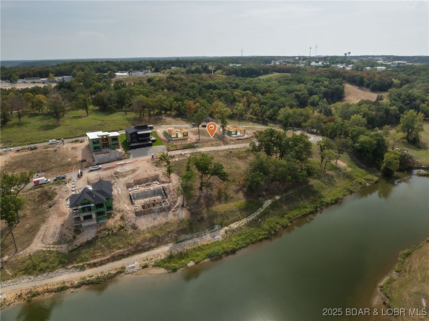 Come build your dream home or use the sellers current plans in the newest lake community at Lake of the Ozarks! Harpers Cov in Osage Beach provides lakeside pool with clubhouse, community docks all accessible by your golf cart  for easy access around the community and to the docks.  City water, city sewer, city maintained streets, natural gas, community trash, sidewalks, streetlights, and highspeed internet.   This Lot one of the larger second tier lots (81x110x83x110) with gentle slope - would make an ideal walk out!.  Minutes from Hospital, shopping, restaurant's and popular lakefront attractions. Great location by land and water.  12x36 dock slip available.