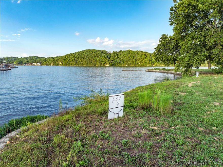 Welcome to Kamden Estates, an exclusive new development on a picturesque point at the 44MM of Lake of the Ozarks. Presenting Lot 6—an exceptional opportunity to own a prime piece of lakefront. This lot features approximately 141 ft of pristine lakefront and spans about 1/2 of an acre. The land has been improved to elevate from the floodplain and a seawall is already in place. The community will feature on-site sewer treatment and community water services. While connection fees for utilities are still to be determined, this lot offers an incredible foundation for your dream home, with a minimum build requirement of 3,000+ square feet. What sets Kamden Estate apart is its remarkably flat terrain, allowing you to build just steps from the water’s edge—perfect for those who want to live the ultimate lakeside lifestyle. Enjoy calmer waters ideal for swimming and boating, while still being close to popular local spots like Boondocks and Bear Bottoms. Don’t miss your chance to be part of this exclusive community. Lot 6 at Kamden Estates is where your vision of luxurious lakeside living becomes reality