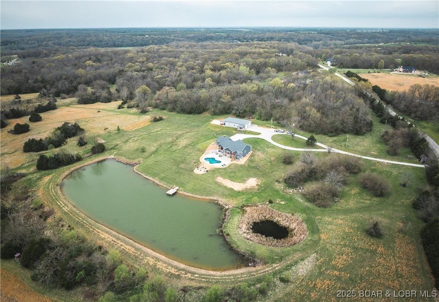 Dawnview Estate is located close to Truman Lake and minutes from Sterett Creek Marina! This stunning 4,400 m/l sq ft home offers 2x6 exterior walls with spray foam insulation, heated bathroom floors, and accent lighting inside and out. The kitchen boasts a granite countertop, quartz island, and a hidden giant walk-in pantry. Also a 40x60 shop with a 16x40 lean to and 400m/l sqft living quarters. Outside, enjoy a pool and spa area less than two years old and a large pond stocked with Bass and panfish, and fruit trees have been planted as well. The property also includes, a hidden safe room accessed through a bookcase, and breathtaking sunrise and sunset views to watch while enjoying the sights and sounds of nature. Property to be surveyed prior to closing.