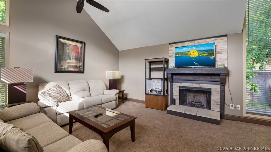 Exceptional opportunity for a personal Lake getaway, second home, or income-producing investment in sought-after Tan Tar A Estates. This spacious approx. 1,300 sq ft home features an open-concept kitchen, dining, and living area with vaulted ceilings, a cozy fireplace, and expansive windows that flood the space with natural light while capturing beautiful golf course and lake cove views. Multiple outdoor living areas enhance the appeal, including a large open deck perfect for grilling and entertaining, a screened covered deck for year-round enjoyment, and private decks off both bedrooms. One bedroom is generously sized to accommodate two beds, making it ideal for guests and maximizing rental flexibility. Recent improvements include two new PTAC wall units, a new water heater, and updated decking. Residents enjoy access to two community outdoor pools, while the location adjacent to Margaritaville Lake Resort Lake of the Ozarks places owners and guests just moments from golf, the indoor water park, spa, marina, riding stables, dining, and LandShark Bar & Grill. A prime location for enjoying the Lake lifestyle while offering excellent vacation rental or seasonal retreat potential.