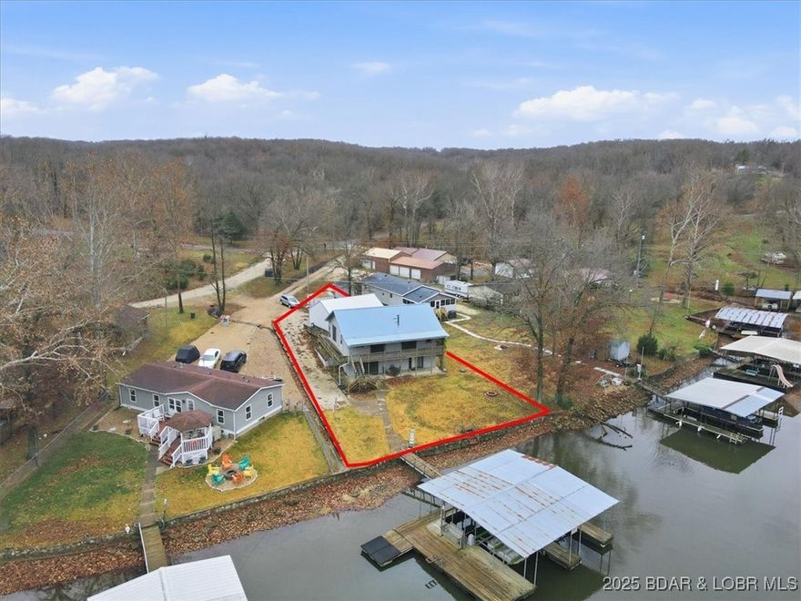 LAKEFRONT WITH A THREE CAR GARAGE!! Fantastic lakefront fixer-upper with endless potential! Enjoy a level yard with firepit, plenty of parking, and a detached 3-car garage—perfect for lake toys and storage. This property offers 72 feet of waterfront in a peaceful cove and a 2-well dock already in place. Close to fun lake of the Ozarks waterfront venues. 

Inside, you'll find a cozy open-concept layout with multiple sliders leading to a covered deck and a charming wrap-around porch. The walkout lower level provides additional unfinished space to customize to your style.

A great opportunity to create your ideal lake getaway in a friendly neighborhood where boating, fishing, and summer fun are right at your doorstep. Don’t miss it! 3rd bedroom is non-conforming.

*This property is under contract with a 72 hour kickout clause*