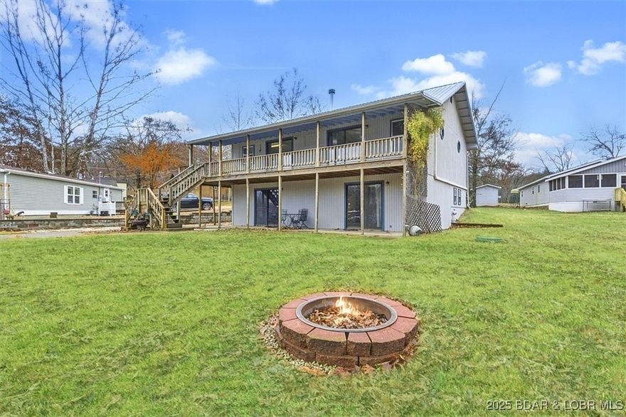 LAKEFRONT WITH A THREE CAR GARAGE!! Fantastic lakefront fixer-upper with endless potential! Enjoy a level yard with firepit, plenty of parking, and a detached 3-car garage—perfect for lake toys and storage. This property offers 72 feet of waterfront in a peaceful cove and a 2-well dock already in place. Close to fun lake of the Ozarks waterfront venues. 

Inside, you'll find a cozy open-concept layout with multiple sliders leading to a covered deck and a charming wrap-around porch. The walkout lower level provides additional unfinished space to customize to your style.

A great opportunity to create your ideal lake getaway in a friendly neighborhood where boating, fishing, and summer fun are right at your doorstep. Don’t miss it! 3rd bedroom is non-conforming.

*This property is under contract with a 72 hour kickout clause*