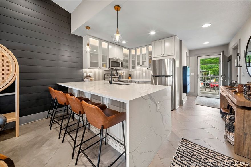 Stunning remodeled top-floor condo in a prime Lake Ozark location just minutes from the famous Bagnell Dam Strip! Step inside and fall in love with the expansive open floor plan, beautifully updated from top to bottom with modern finishes, luxurious details, and stylish high-end furnishings throughout. This completely turnkey condo is move-in ready, offering the ease and comfort of lake living without the work. The bright, open living area flows seamlessly to a spacious screened-in back deck where you can relax, unwind, and take in gorgeous lake views. The updated bathroom features a sleek walk-in shower, adding to the fresh, elevated feel of the space. Whether you are looking for your own lake escape, a low-maintenance retreat, or an income-producing opportunity, this condo checks every box. Rentals are allowed, making it a fantastic option for personal enjoyment and potential investment. Beautifully furnished, thoughtfully remodeled, and perfectly positioned near shopping, dining, entertainment, and lake attractions, this top-floor gem is your perfect Lake Ozark oasis!